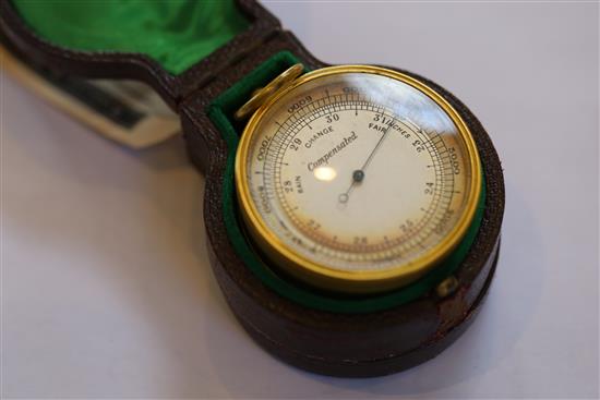 A cased pocket barometer / compass, together with a brass pocket barometer